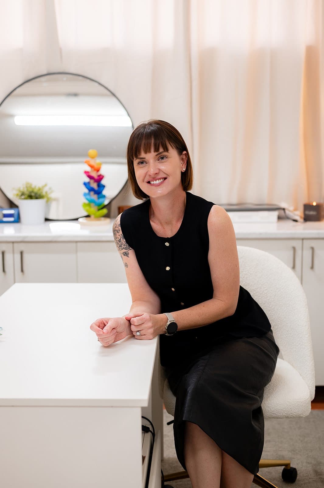 Dr Alison Collins seated at the desk in the Andergrove consulting room